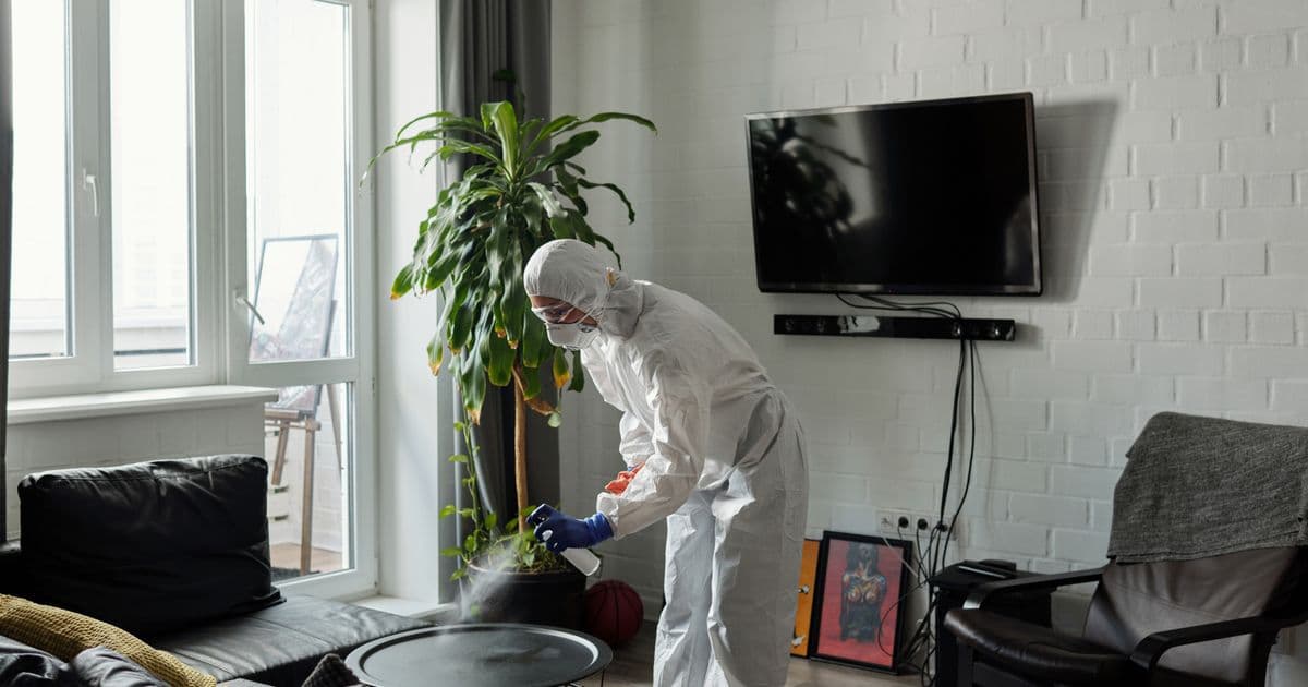 Fachkraft in Schutzausrüstung bei einer intensiven Grund- und Desinfektionsreinigung – höherer Quadratmeterpreis